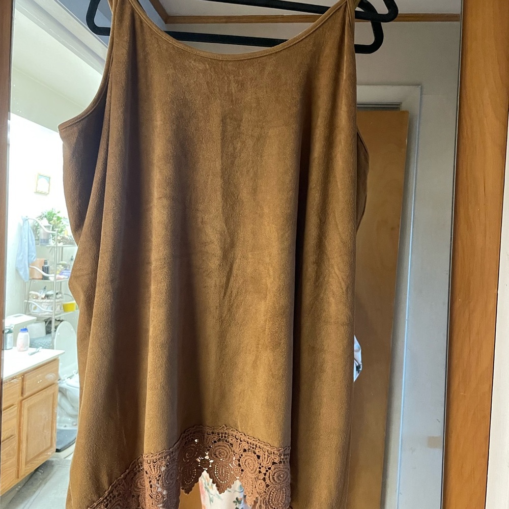 Soft suede like fabric. Excellent under a Jean jacket or western theme